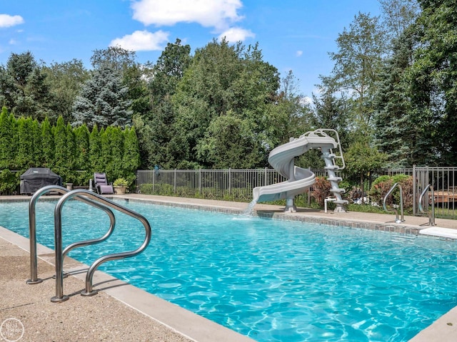 view of pool with a water slide