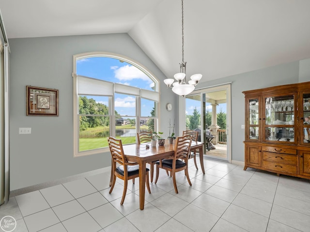 dining area featuring vaulted ceiling, an inviting chandelier, and light tile patterned flooring