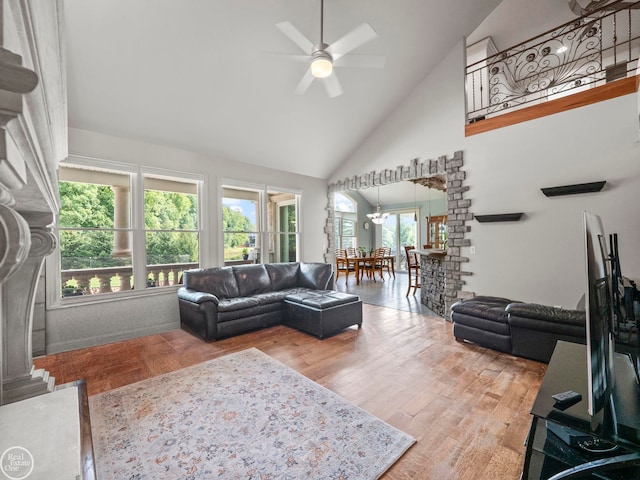 living room featuring hardwood / wood-style floors, high vaulted ceiling, ceiling fan, and a healthy amount of sunlight