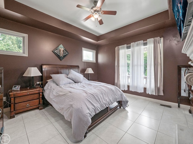 bedroom with ceiling fan, multiple windows, and light tile patterned floors