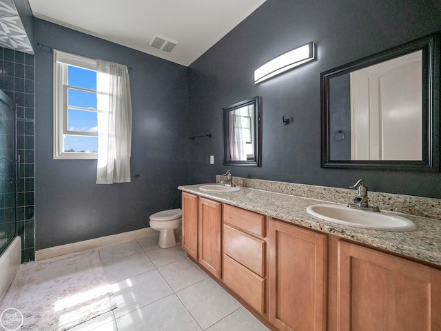 full bathroom featuring tile patterned flooring, toilet, tiled shower / bath combo, and vanity