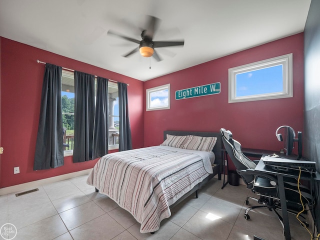 tiled bedroom featuring ceiling fan