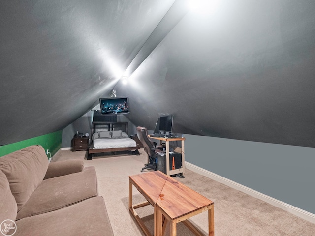 carpeted cinema room featuring vaulted ceiling