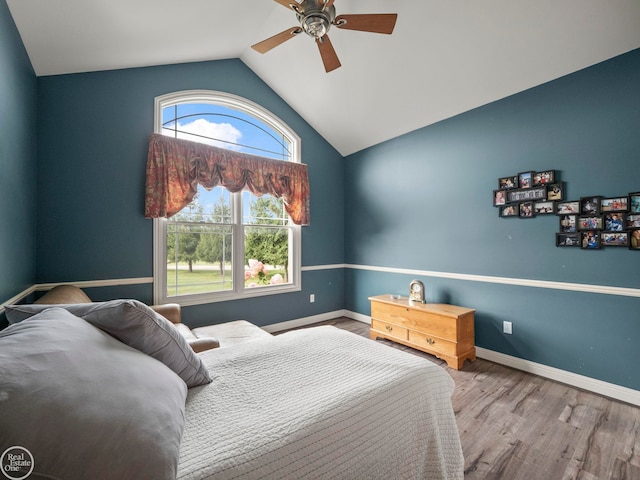 bedroom with ceiling fan, lofted ceiling, and hardwood / wood-style floors