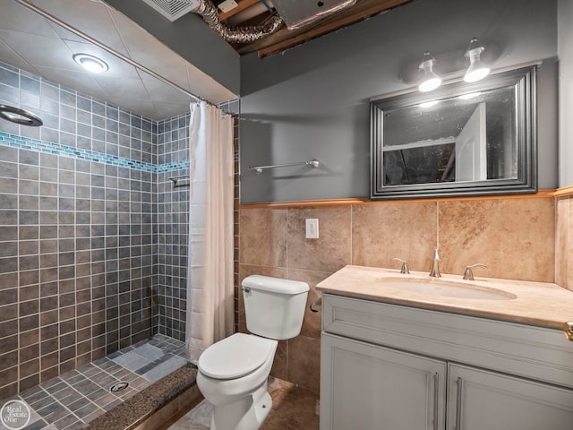 bathroom featuring a shower with curtain, toilet, tasteful backsplash, vanity, and tile walls