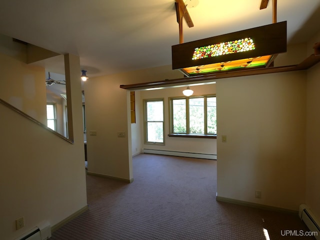 spare room with ceiling fan, carpet, and a baseboard radiator