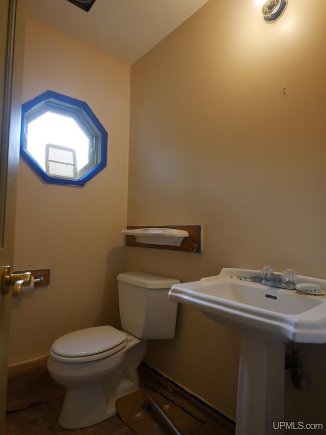 bathroom with tile patterned flooring and toilet