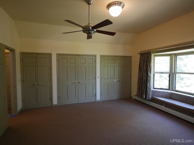 unfurnished bedroom with ceiling fan, carpet flooring, multiple closets, and lofted ceiling