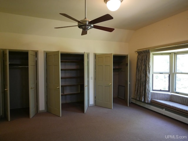 unfurnished bedroom with carpet, a baseboard radiator, multiple closets, lofted ceiling, and ceiling fan