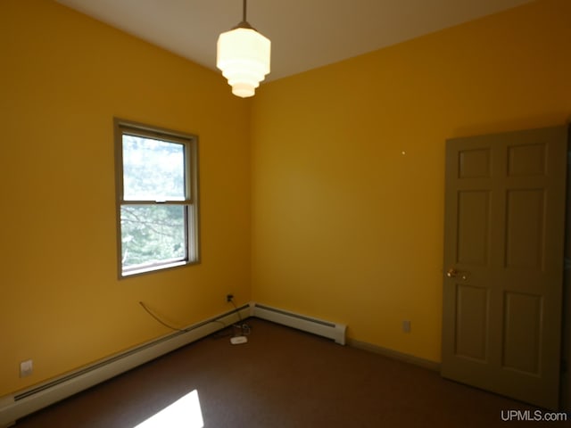 empty room with a baseboard radiator and carpet