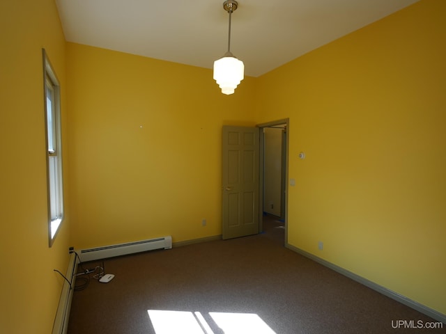 spare room with carpet flooring and a baseboard radiator