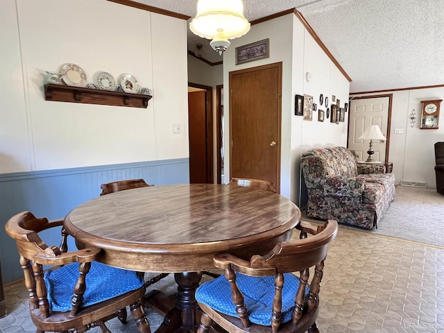 dining area featuring a textured ceiling, visible vents, vaulted ceiling, ornamental molding, and carpet