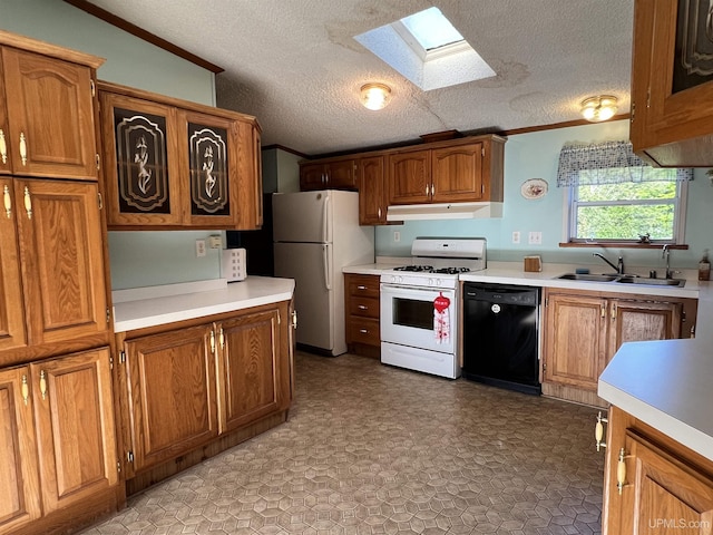 kitchen with under cabinet range hood, white appliances, a sink, light countertops, and crown molding