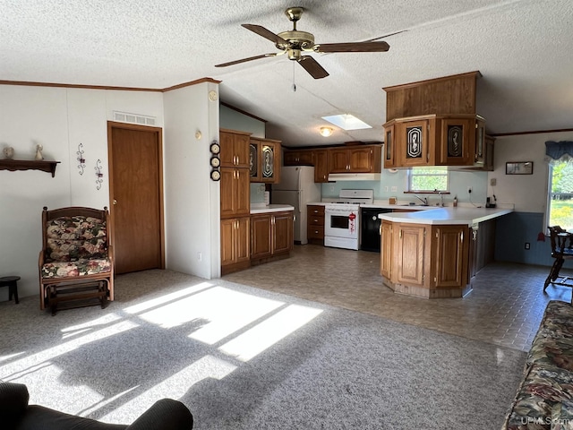 kitchen with white appliances, visible vents, lofted ceiling with skylight, light countertops, and a textured ceiling