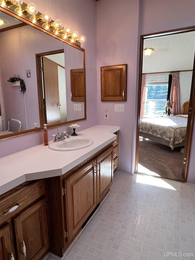 bathroom with ensuite bathroom and vanity