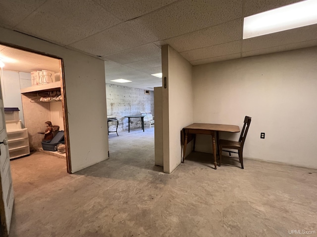 finished basement featuring a paneled ceiling