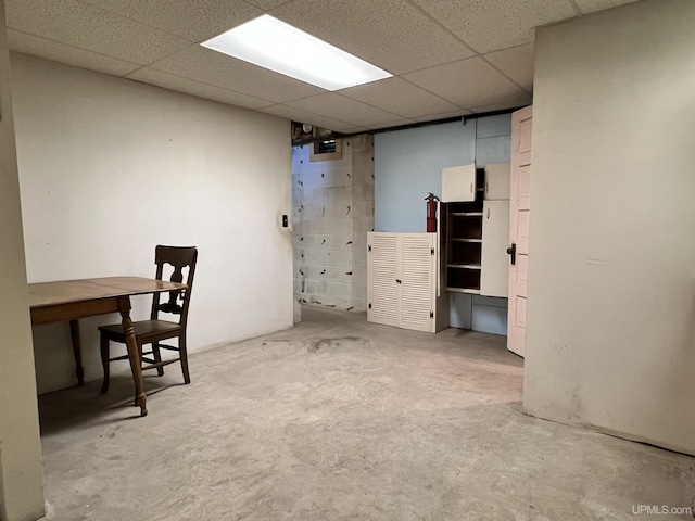 unfurnished office featuring concrete floors and a paneled ceiling