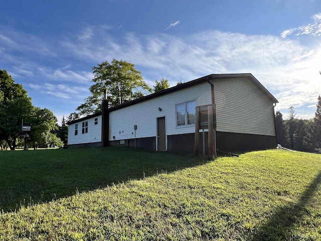 view of side of home with a lawn