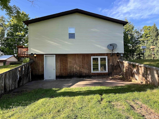 back of house with a patio, a lawn, and fence