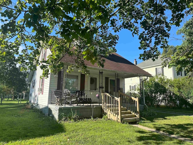 view of front of house featuring a front yard and a porch