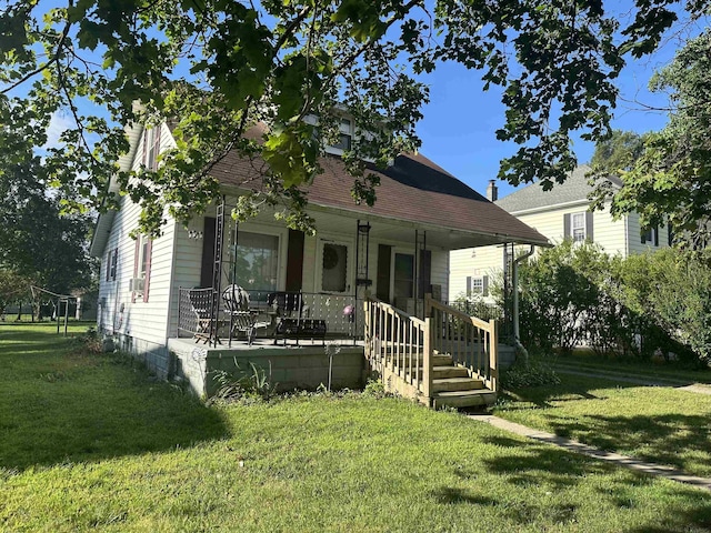 view of front of property featuring covered porch and a front lawn