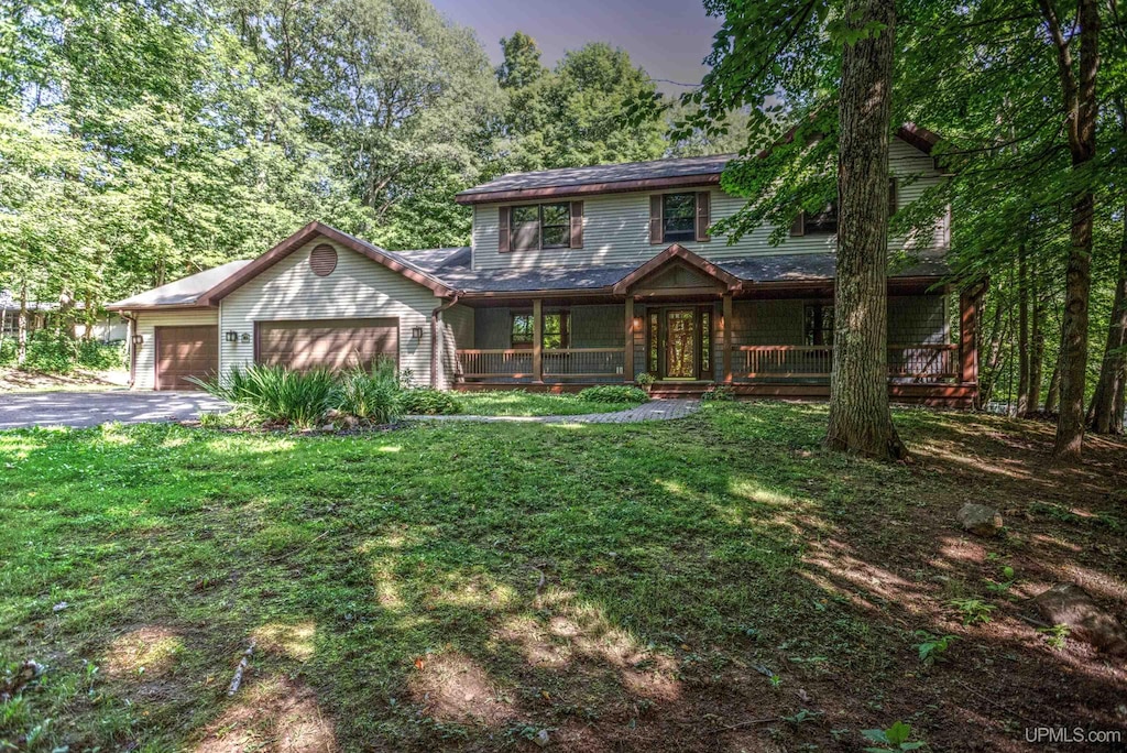 view of front of property with a garage and a front yard