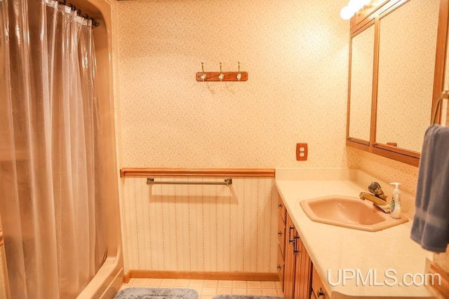 bathroom featuring shower with separate bathtub, tile patterned flooring, and vanity