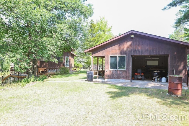 exterior space with a garage and a lawn