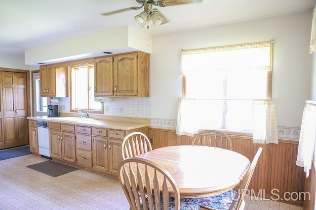 tiled dining area featuring ceiling fan and sink