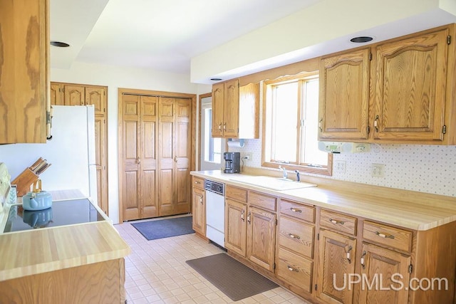 kitchen featuring sink, white appliances, and light tile patterned floors