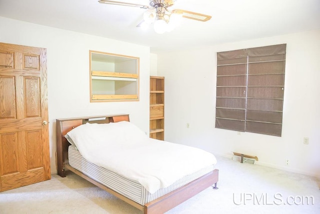 bedroom featuring ceiling fan and light carpet