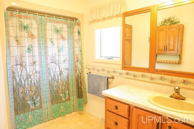 bathroom with tile patterned flooring and vanity