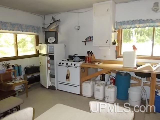 kitchen with white cabinetry and white range with gas stovetop