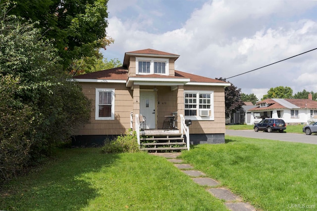 bungalow-style house featuring a front yard