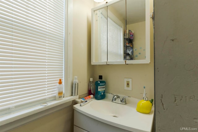 bathroom featuring a wealth of natural light and vanity