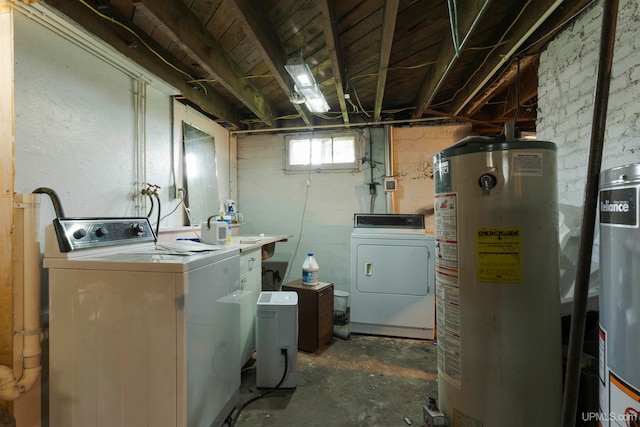 laundry room with gas water heater and washing machine and clothes dryer