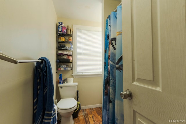 bathroom with toilet and wood-type flooring