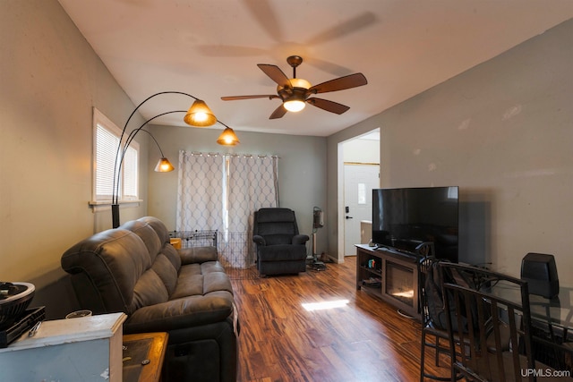 living room featuring dark hardwood / wood-style flooring and ceiling fan