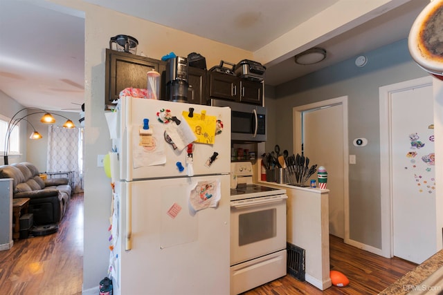 kitchen featuring dark wood-type flooring and white appliances