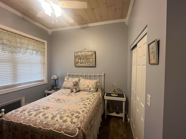 bedroom with a closet, dark wood-type flooring, crown molding, ceiling fan, and wooden ceiling