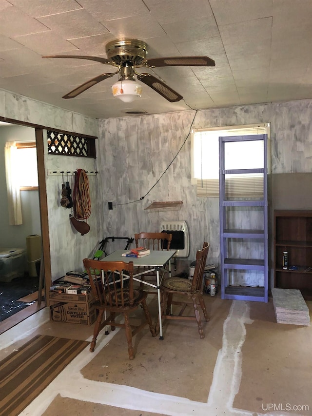 dining area featuring ceiling fan and concrete floors