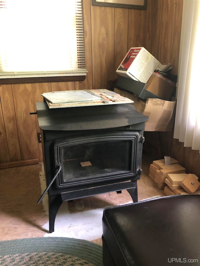 room details featuring wood walls and a wood stove