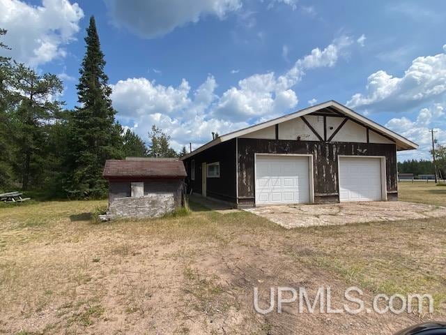 exterior space featuring an outbuilding and a garage