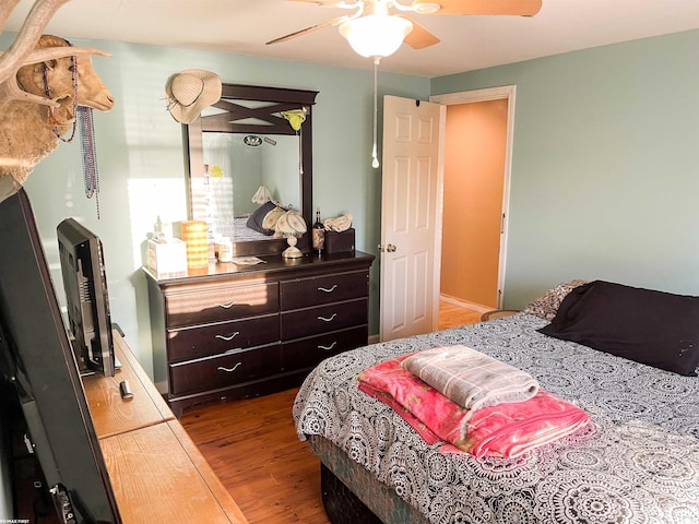 bedroom with ceiling fan and hardwood / wood-style flooring