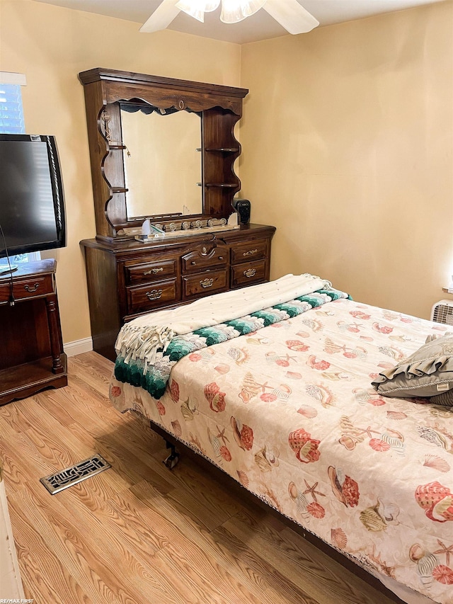 bedroom with light wood-type flooring and ceiling fan