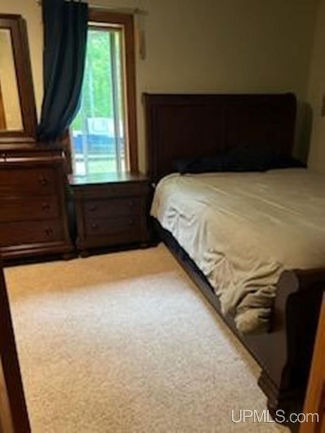 bedroom featuring light colored carpet