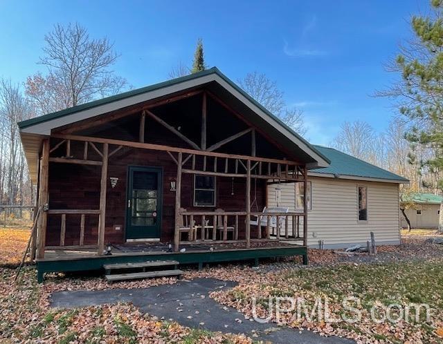 view of front of home with covered porch and metal roof