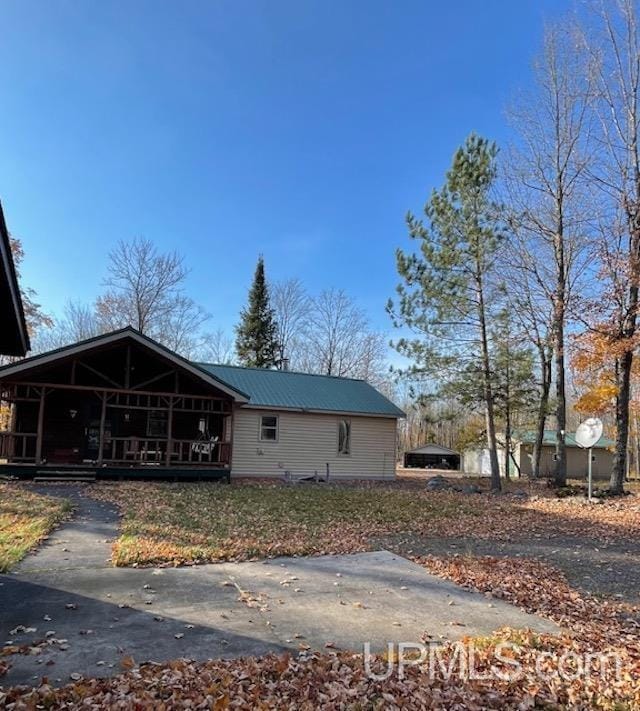 view of front of property with a porch and metal roof