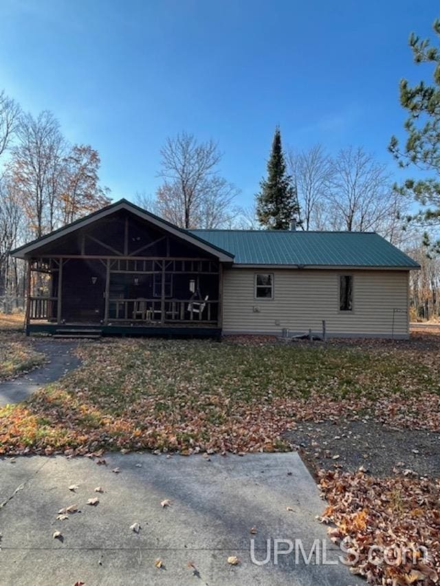 view of front of property featuring covered porch and metal roof