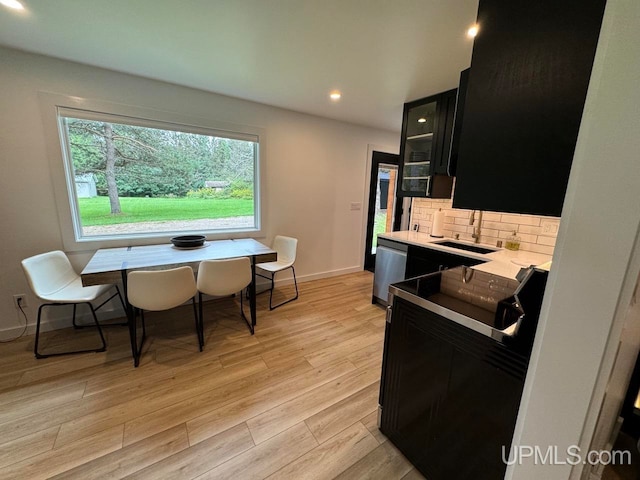 kitchen with light hardwood / wood-style flooring, sink, black electric range, tasteful backsplash, and stainless steel dishwasher